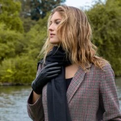 Women’s Touchscreen Three-Point Cashmere-Lined Leather Gloves -Dents Luxury Accessories Sales woman wearing black cashmere lined leather gloves